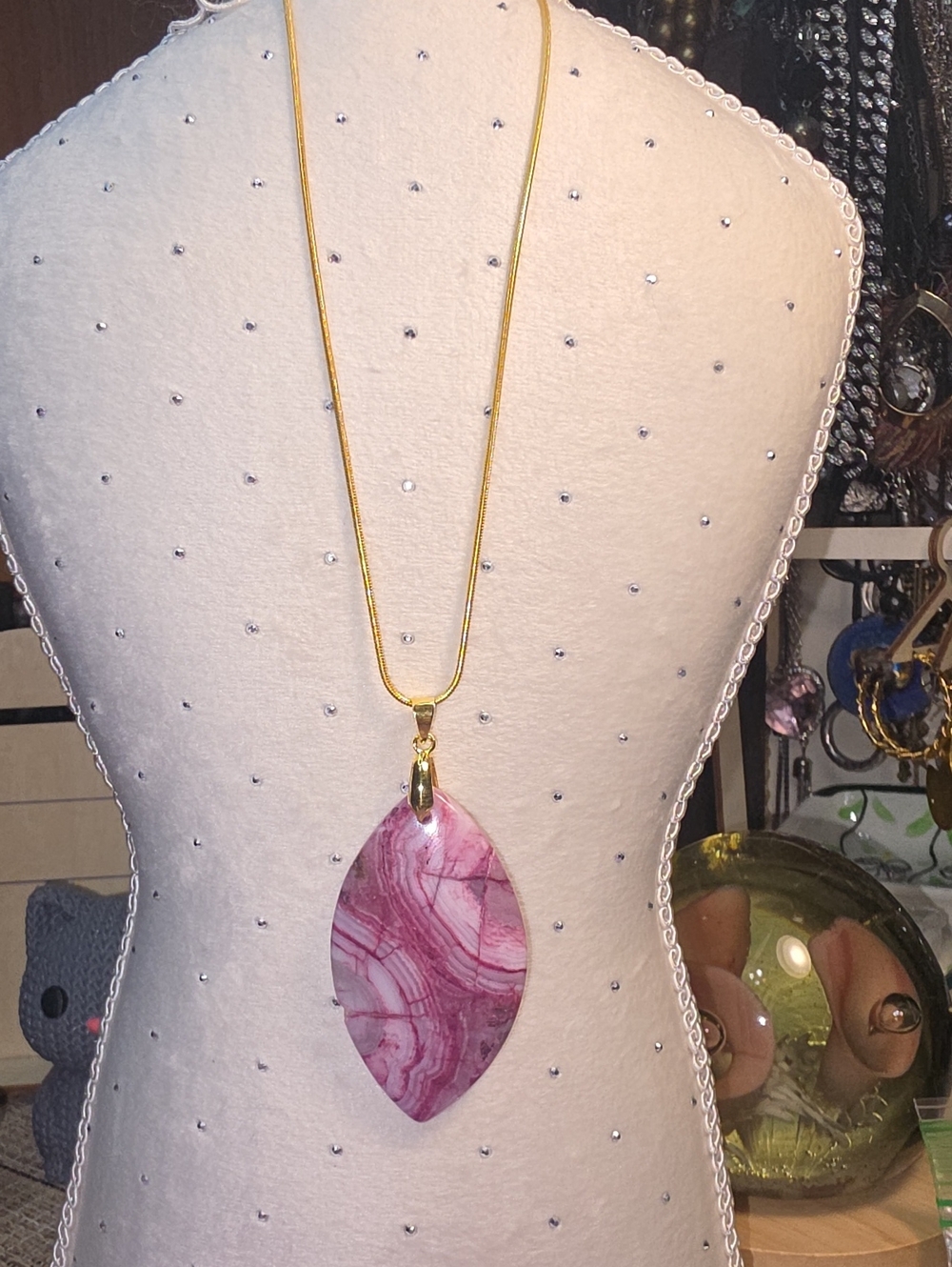 Rhodochrosite Pendant necklace features a Marquise-shaped pink stone